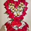 Heart-shaped rose arrangement with gold-wrapped chocolates and baby's breath