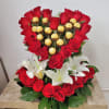 Heart-shaped bouquet of red roses with white lilies and gold-wrapped chocolates