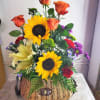 Basket arrangement with sunflowers, orange roses, and mixed daisies