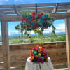 Bright multicolored floral arrangements on a table and hanging overhead