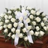 A serene cascade of densely clustered white roses creates the centerpiece of