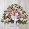 A graceful pedestal arrangement of pink and white blooms makes an immediate