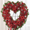 A large heart-shaped sympathy arrangement in vivid red-this floral tribute combines roses