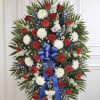 A formal, ceremonial standing spray in red, white &amp; blue crafted for