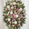 A soft, formal tribute of pastel lilies and roses-this standing spray with