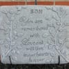 Memorial stone engraved with the words "SON" and a remembrance message