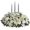 White floral centerpiece with three tall candles