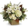 White lilies and roses arranged in a wooden cube vase