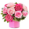 Pink and blush roses arranged in a pink box vase