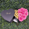 Heart-shaped box with pink roses and gold chocolates