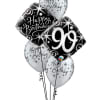 Cluster of birthday balloons with a large black "90" balloon