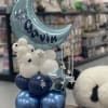Blue moon balloon with white and navy balloons and a teddy bear
