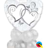 Heart-shaped white balloon with silver heart graphics and white balloons below