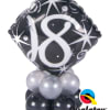 Black number 18 balloon with silver balloons at the base