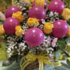 Basket arrangement with yellow roses and pink balloons