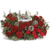 Red roses arranged with a small winter village centerpiece