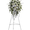 White funeral spray on a standing easel with ribbon