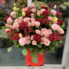 Bouquet of red and pink roses in a red hat box