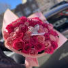 Bouquet of pink and hot pink roses with a butterfly pick