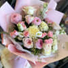 Pink and cream rose bouquet wrapped in pastel paper