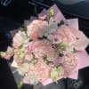 Pink and white bouquet with roses and lisianthus wrapped in pastel paper