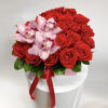 Red roses with pink orchids in a white box tied with a red ribbon