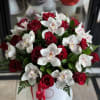 Bouquet of red roses and white orchids in a white hat box with a red ribbon