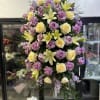 Tall standing floral spray with lavender roses and pale yellow lilies