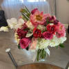 Pink and white mixed bouquet in a glass vase with a Mother's Day tag