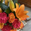 Bouquet of orange lilies and pink carnations with orange roses