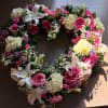 Heart-shaped floral wreath with pink and white flowers
