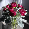 Bouquet of deep pink peonies in a clear glass vase