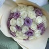 Bouquet of white and lavender roses wrapped in cream paper