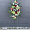 Standing floral spray with red roses, white lilies, and green hydrangeas