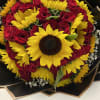 Bouquet of red roses and yellow sunflowers wrapped in black paper