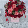 Pink and red rose bouquet in a pink box with ribbon bows