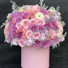 Pink and purple rose bouquet in a pastel pink box