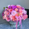 Large pink bouquet in a stone vase with ribbon tails