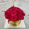 Hot pink roses in a gold striped box with a heart pick