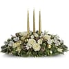 Holiday centerpiece with white roses and gold candles