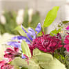 Bouquet of purple and pink flowers with green leaves