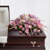 Pink and lavender floral spray on a casket