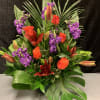 Tropical bouquet with orange roses, lilies, and purple flowers