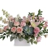 Pink roses and lilies in a white rectangular vase
