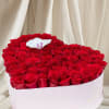Heart-shaped box of red roses with a white orchid on top