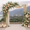 Floral wedding arch with peach and white roses and draped fabric