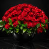 Large bouquet of red roses in a black vase