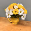 Happy face tea cup with yellow and white daisies along with yellow