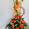 Tall orange floral arrangement with roses and gladiolus
