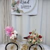 Gold bicycle decor with a small floral arrangement and teddy bear